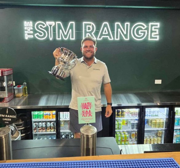 Mitch Smith with the 2026 PGA Professionals Championship trophy at The Sim Range bar